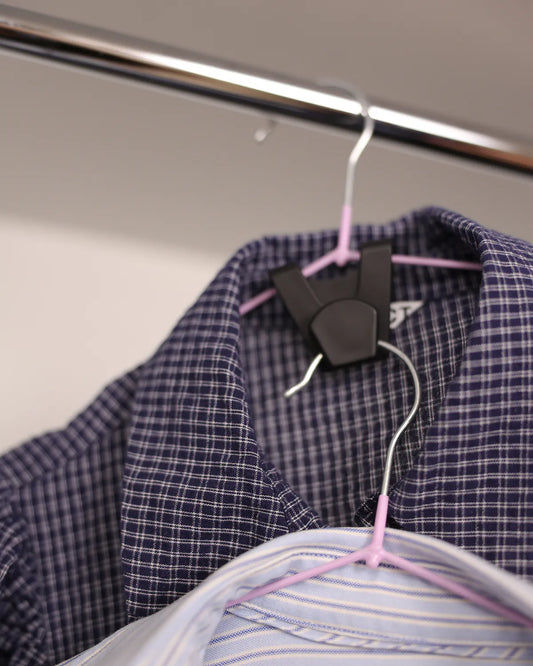 Hanger connector holding two tops on one hanger