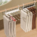 Pants hangers holding trousers, six come in The Family Closet Set